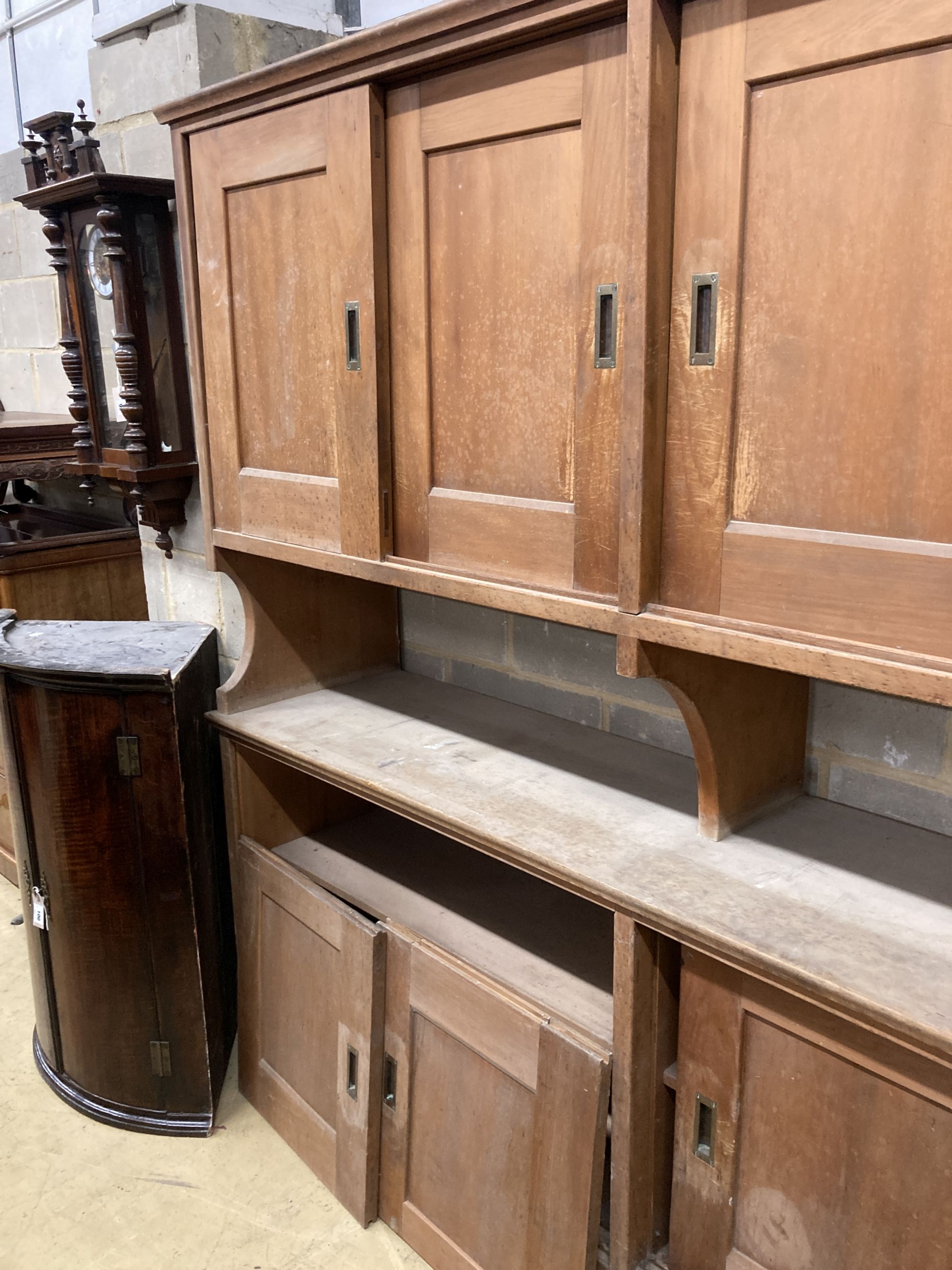 Two mid century pine and fruitwood sliding door household cupboards, larger 245cm, depth 47cm, height 204cm